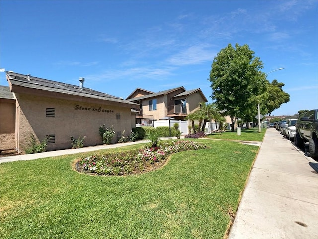 view of property exterior with a lawn and stucco siding