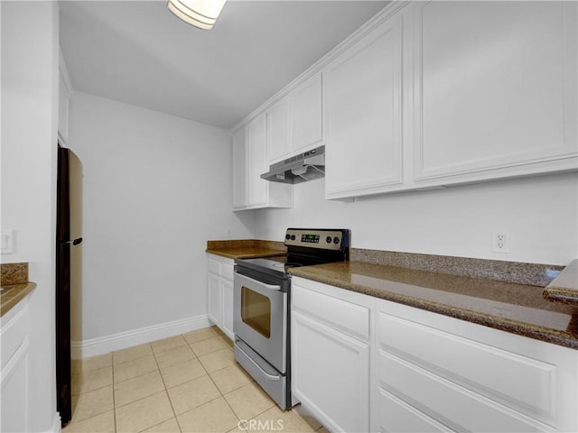 kitchen featuring stainless steel electric stove, dark countertops, freestanding refrigerator, white cabinets, and under cabinet range hood