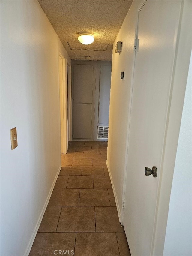 27865 Quincy St, Castaic, CA 91384 - hallway with dark tile patterned flooring and a textured ceiling