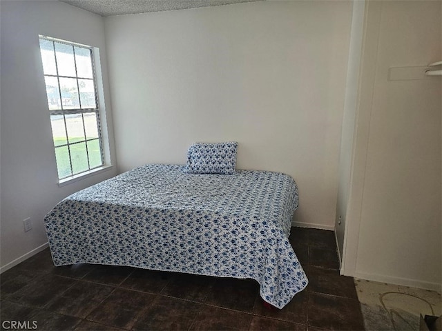 27865 Quincy St, Castaic, CA 91384 - bedroom featuring dark tile patterned floors and a textured ceiling