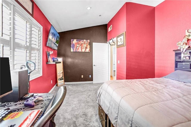 bedroom with carpet, visible vents, vaulted ceiling, and baseboards