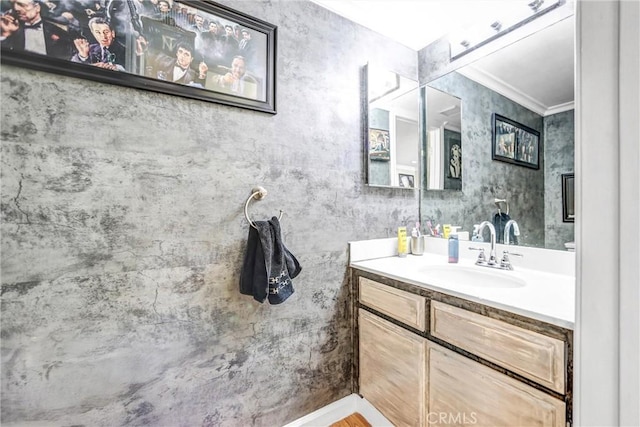 bathroom with ornamental molding and vanity