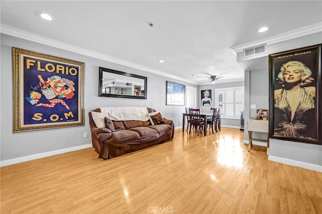 living room featuring crown molding, recessed lighting, visible vents, wood finished floors, and baseboards