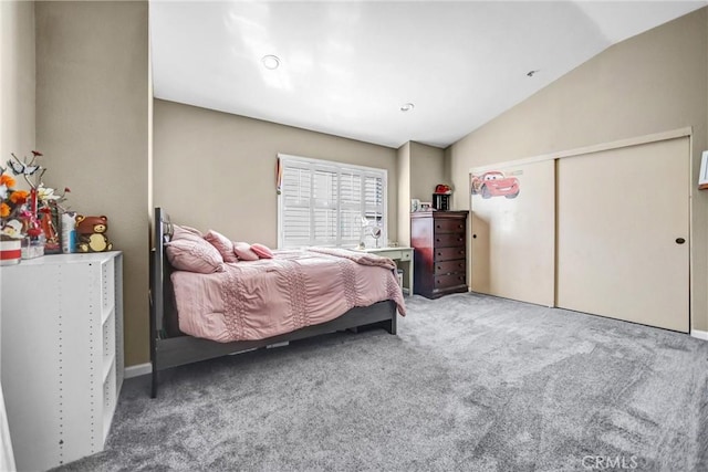 bedroom featuring vaulted ceiling, a closet, and carpet flooring