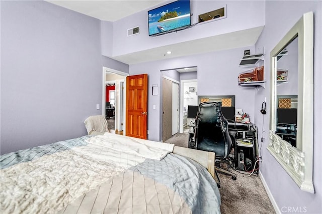 carpeted bedroom with baseboards, a high ceiling, and visible vents