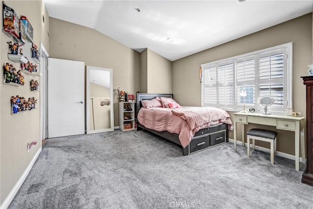 bedroom featuring lofted ceiling, baseboards, and carpet