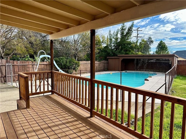 wooden deck featuring a fenced backyard and a fenced in pool