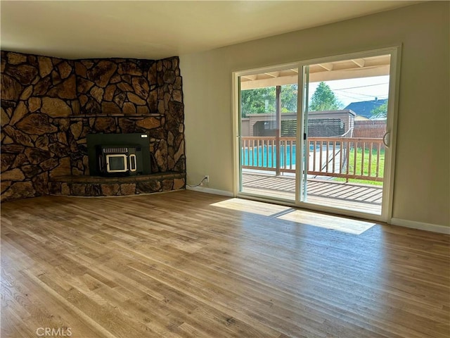 unfurnished living room featuring baseboards and wood finished floors