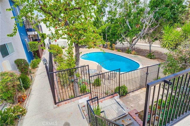 pool featuring a patio area and fence