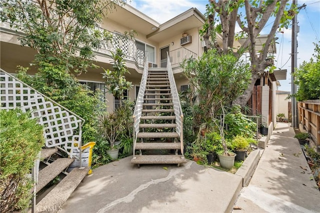 view of property with stairs and fence