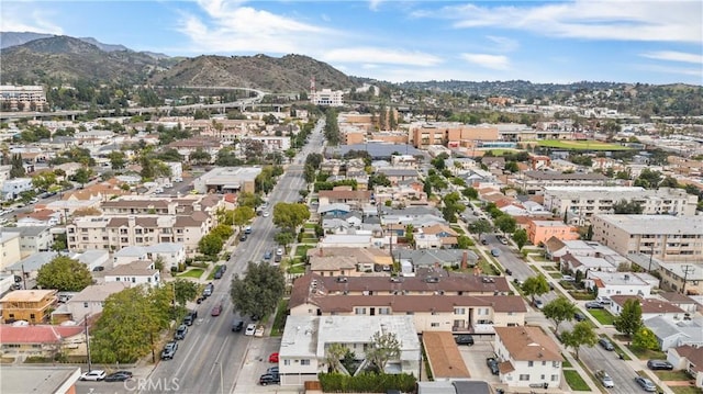 drone / aerial view featuring a residential view and a mountain view