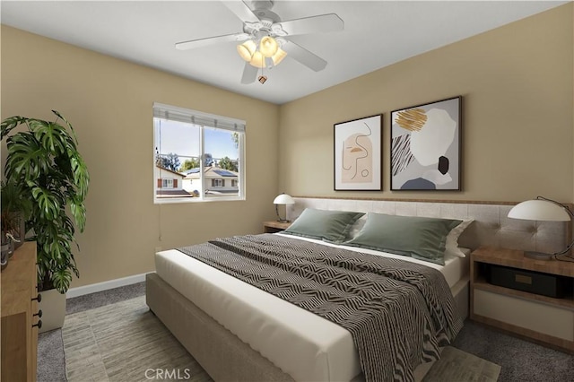 bedroom with a ceiling fan, carpet, and baseboards