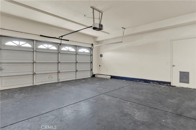 garage with electric panel and a garage door opener