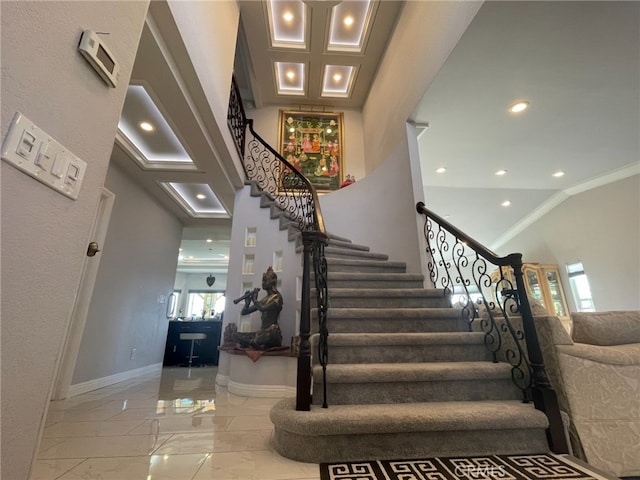 stairs featuring recessed lighting, a high ceiling, baseboards, marble finish floor, and ornamental molding