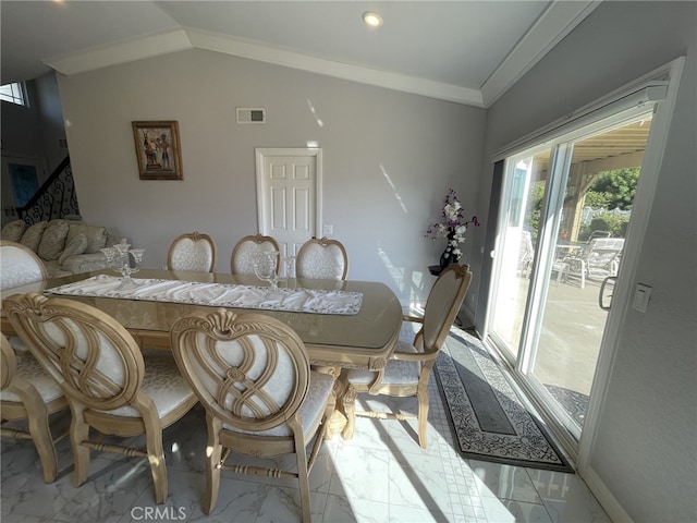 dining space with marble finish floor, visible vents, vaulted ceiling, and ornamental molding