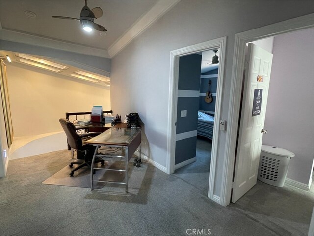 carpeted home office featuring ornamental molding, a ceiling fan, and baseboards