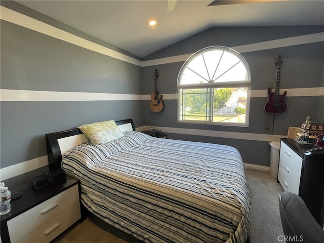 bedroom with vaulted ceiling and light carpet