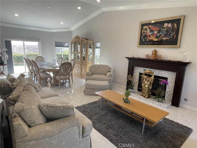 living area featuring baseboards, a fireplace with raised hearth, lofted ceiling, ornamental molding, and recessed lighting