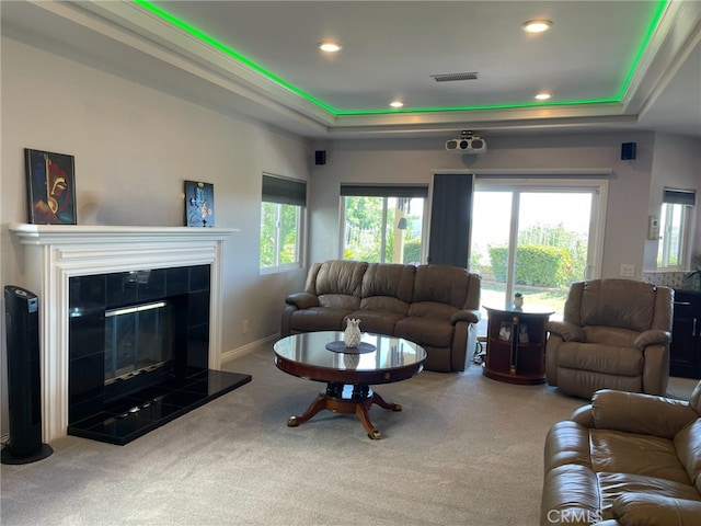 living room with recessed lighting, carpet floors, a fireplace, visible vents, and a tray ceiling