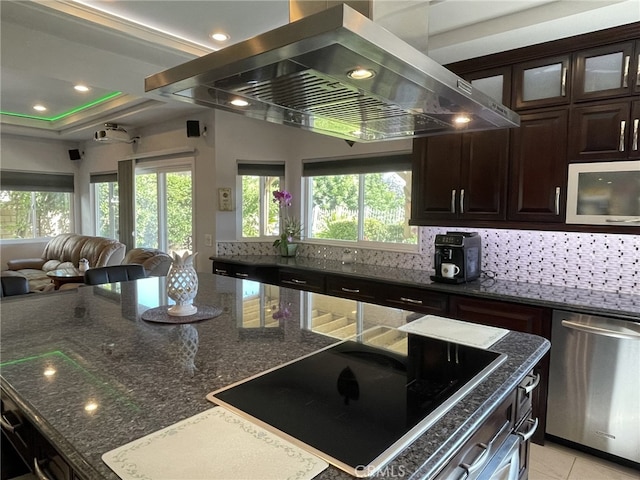 kitchen featuring black electric cooktop, island range hood, open floor plan, stainless steel dishwasher, and decorative backsplash