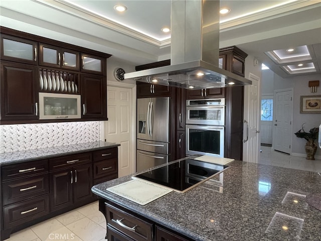 kitchen featuring island range hood, glass insert cabinets, appliances with stainless steel finishes, backsplash, and recessed lighting