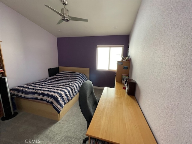 bedroom with a textured wall and ceiling fan