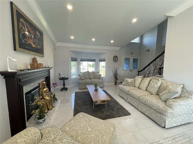 living room featuring recessed lighting, baseboards, marble finish floor, a glass covered fireplace, and crown molding