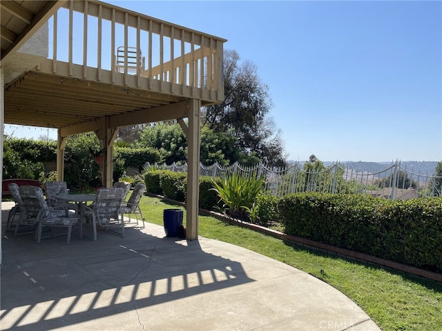 view of patio with outdoor dining space and fence