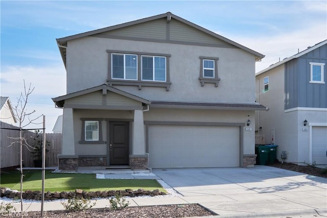 traditional home featuring stone siding, fence, driveway, and stucco siding