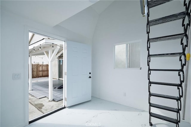 interior space with marble finish floor and vaulted ceiling