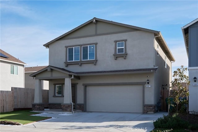 traditional home featuring stucco siding, concrete driveway, an attached garage, fence, and stone siding