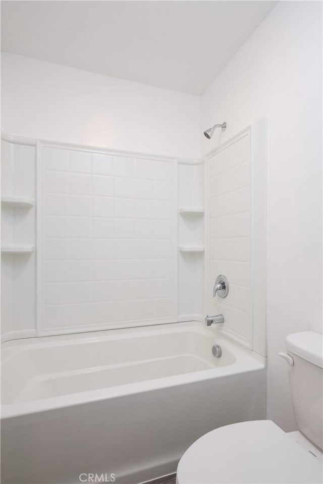 bathroom with shower / bathing tub combination and toilet