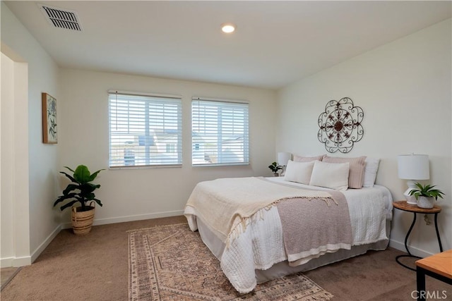 bedroom with baseboards, visible vents, and carpet flooring