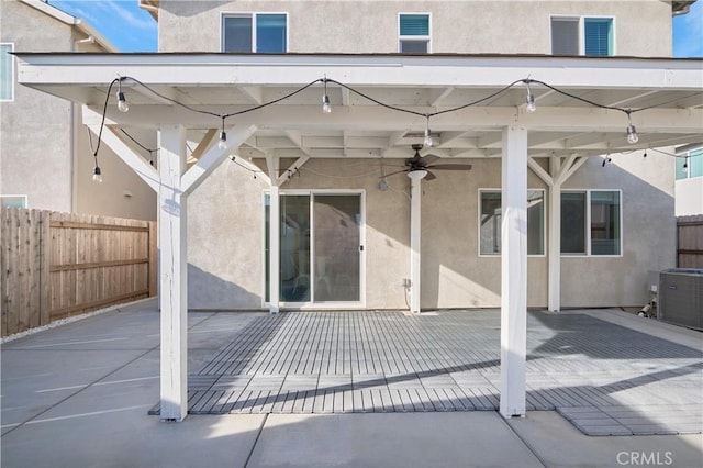 view of patio with fence, a ceiling fan, and central air condition unit