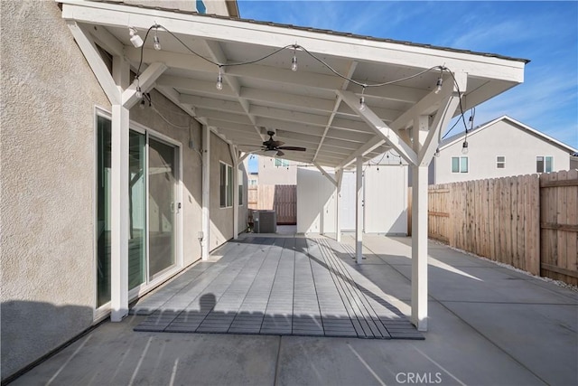 view of patio featuring a fenced backyard, ceiling fan, and central AC