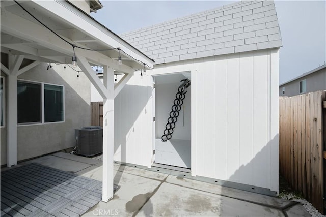 view of patio / terrace featuring central AC unit and fence