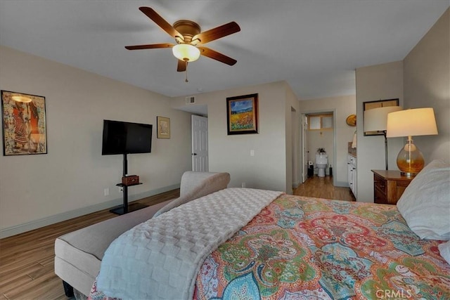 bedroom featuring light wood-style flooring, visible vents, baseboards, and ceiling fan