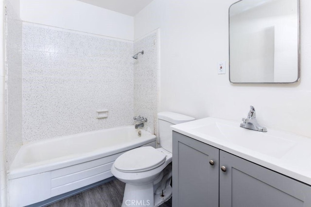 full bathroom featuring shower / bath combination, vanity, toilet, and wood finished floors