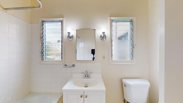 full bath with toilet, a tub, and vanity