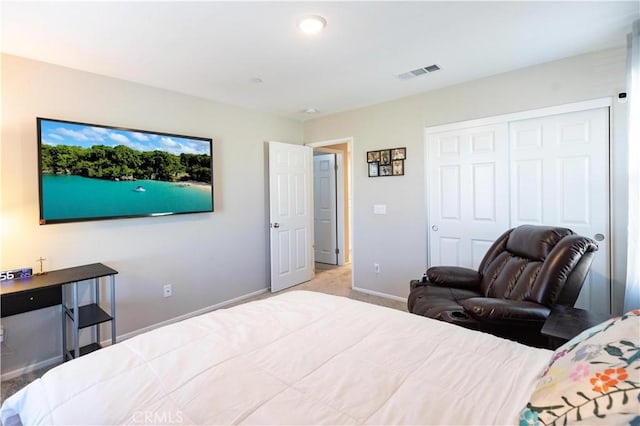 carpeted bedroom with a closet, visible vents, and baseboards