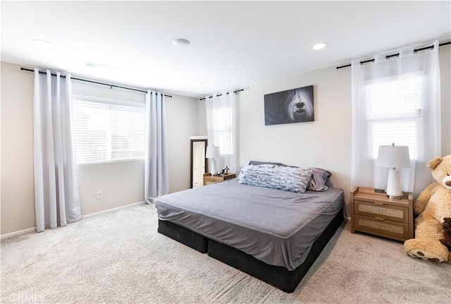 carpeted bedroom with recessed lighting, multiple windows, and baseboards