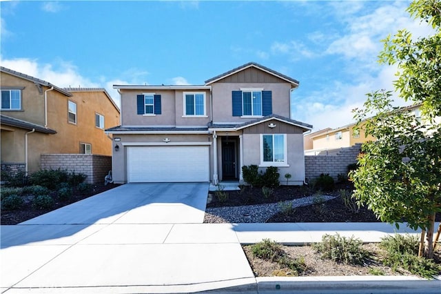 traditional-style house with a garage, driveway, fence, and stucco siding