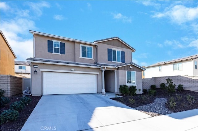 traditional home with concrete driveway, an attached garage, fence, board and batten siding, and stucco siding