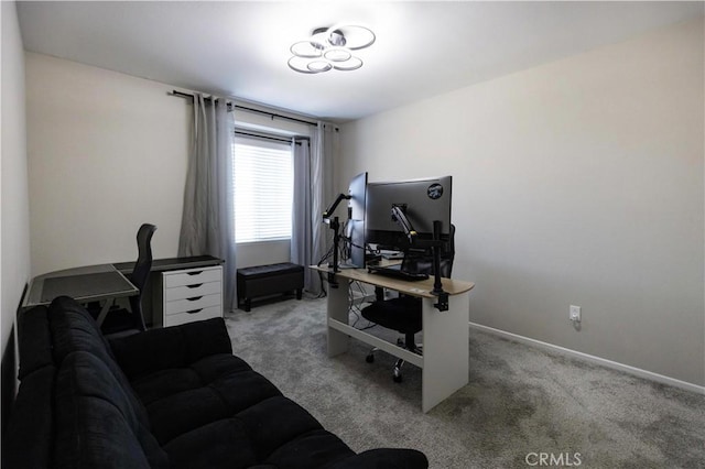 carpeted home office featuring baseboards