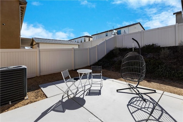 view of patio / terrace with a fenced backyard and central air condition unit