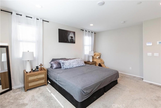 bedroom featuring light carpet, recessed lighting, and baseboards