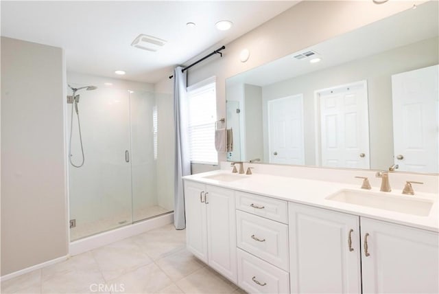 full bathroom featuring visible vents, a sink, a shower stall, and double vanity