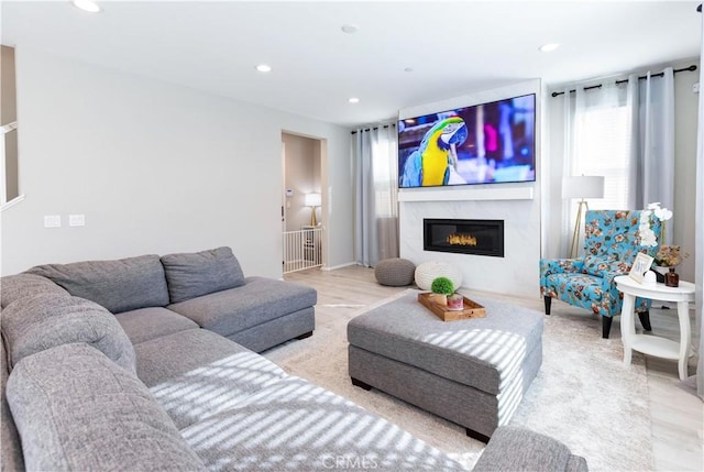 living area featuring a fireplace and recessed lighting