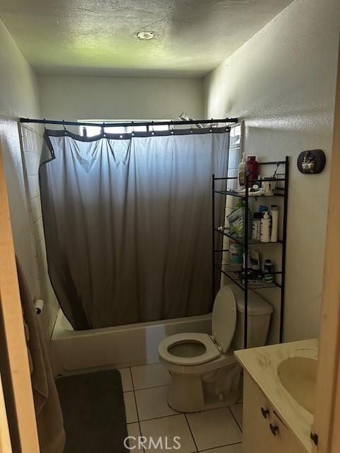 bathroom with tile patterned floors, a textured ceiling, vanity, shower / tub combo, and toilet