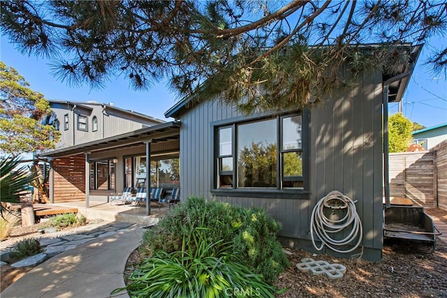 back of house featuring a patio area and fence